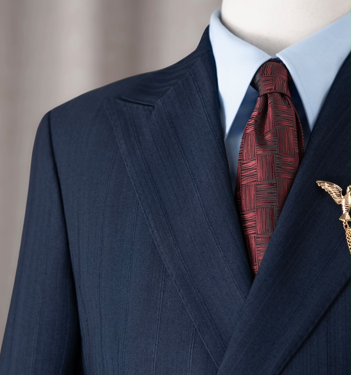Close-up of the navy suit shoulder and textured fabric
