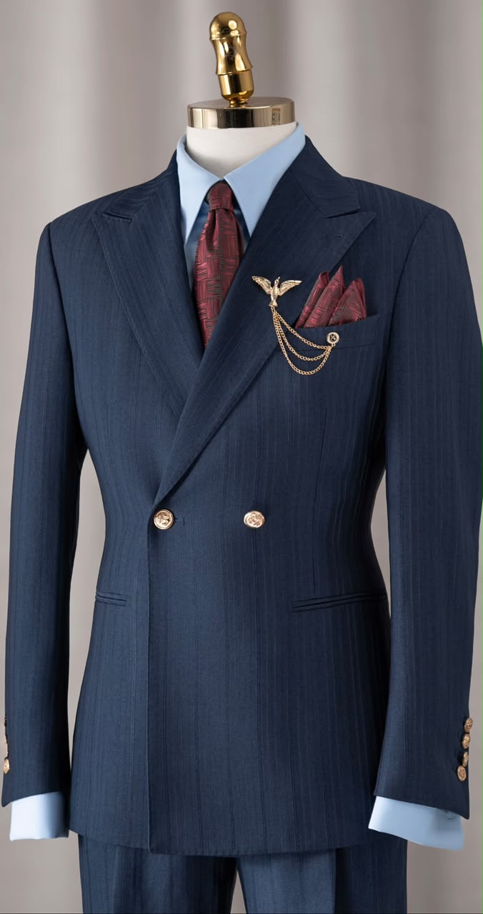 Full navy double-breasted suit on a mannequin, with pale blue shirt and burgundy accessories
