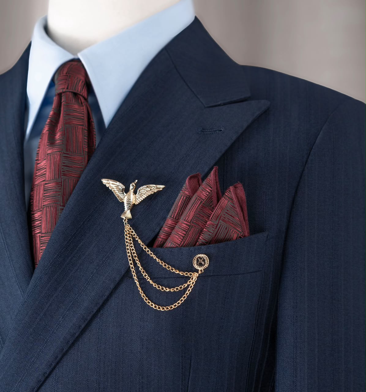 Burgundy pocket square with gold-tone bird brooch and chains