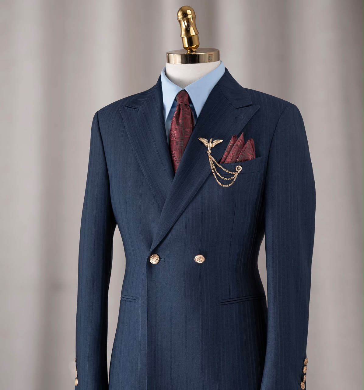 Navy double-breasted suit with burgundy tie and pocket square